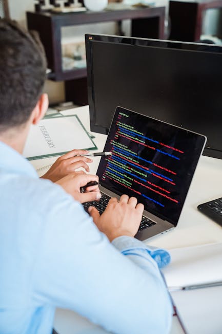 A close-up view of a computer screen displaying lines of colorful programming code, including various keywords, functions, variables, and syntax elements in multiple colors such as red, green, blue, y